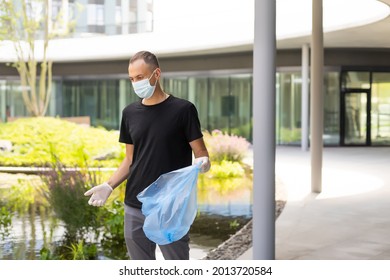 Man Picking Up Plastic Household Waste In Park