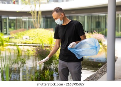 Man Picking Up Plastic Household Waste In Park