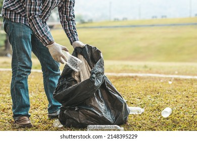 A Man Is Picking Up Trash In A Park, Not Throwing Trash In The Trash Can Ruin The Beauty Of The Garden Area And Also Cause Global Warming And Harm Animals. Concept Of Cleanliness In Public Areas.