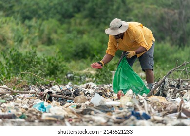 Man Picks Up Plastic Garbage On Beach In The Morning, Panama, Central America.