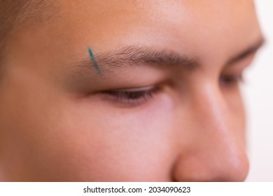 Man With Pierced Eyebrow. Three Small Black Piercings.