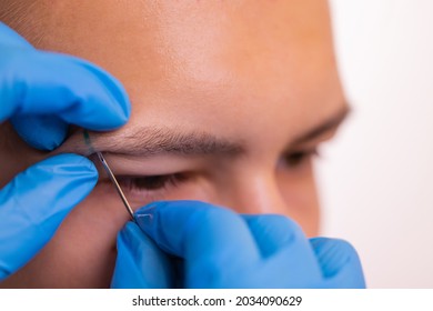 Man With Pierced Eyebrow. Three Small Black Piercings.