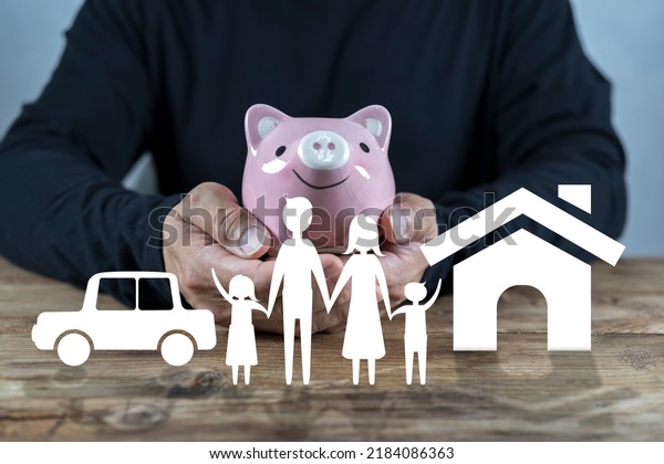 Man with piggy\
bank, home and car. Concept of saving money for house and car.\
Saving money concept,\
insurance