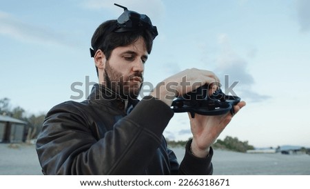 Man pilot a drone with technologic virtual reality glasses and remote controller