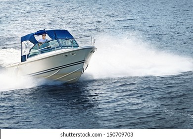 Man piloting motorboat on lake in Georgian Bay, Ontario, Canada.