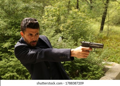 A Man With A Pistol In His Hands