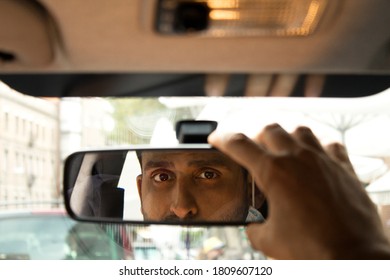 Man Placing Car Rear View Mirror