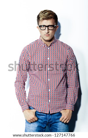 Man in a plaid shirt, jeans, and glasses  on a white background