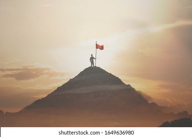 man plants his flag on the mountain peak as a sign of success - Powered by Shutterstock