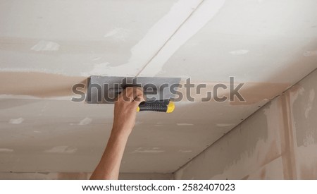 man plastering ceiling repair. Selective focus.