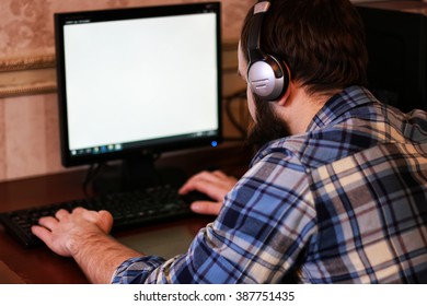 Man Play Computer With Headphones