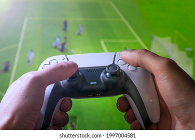 Man play a football game with video game controller.