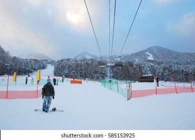 Man  Play Snow Board At Furano Snow Mountain In  Hokkaido, Japan