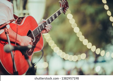 Man Playing Acoustic Guitar On Stage