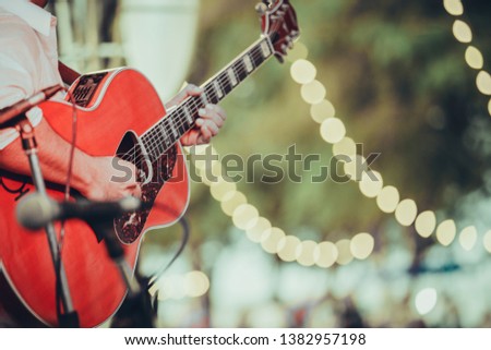 man playing acoustic guitar on stage