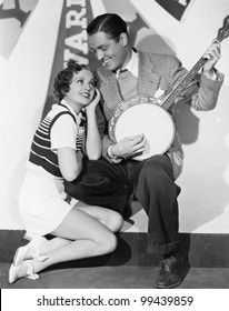 Man Playing Banjo For Adoring Woman