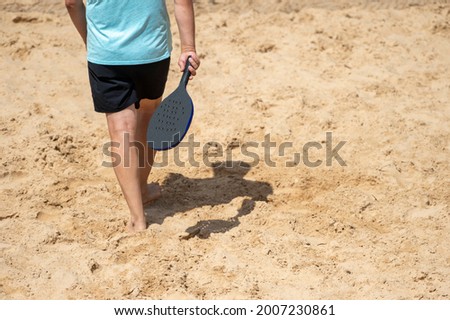 Man playing beach tennis on a beach. Professional sport concept