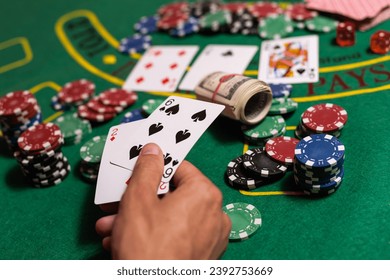 man playing blackjack at the table and betting chips - Powered by Shutterstock