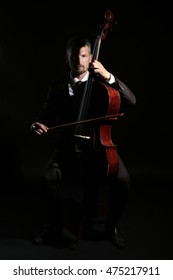 Man Playing Cello In Darkness