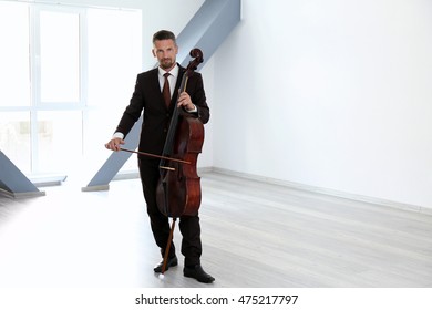 Man Playing Cello In Room