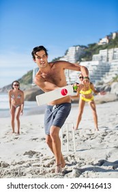 Man Playing Cricket At Beach