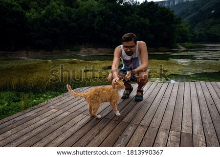 Similar – Foto Bild Rot getigerte Katze am Uferstrand