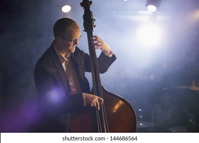 Man playing the double bass on stage