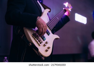 Man Playing Electric Guitar At Night Club