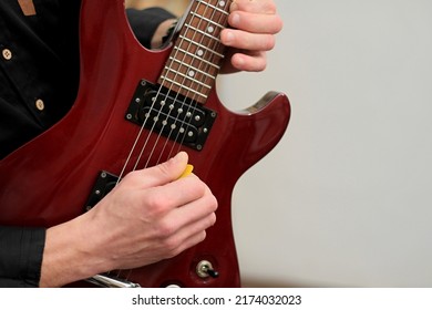 Man Playing Electric Guitar With Pick On White Background Stock Photo