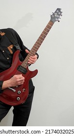 Man Playing Electric Guitar With Pick On White Background Stock Photo