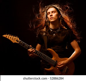 man playing electrical guitar. wind in hair. - Powered by Shutterstock