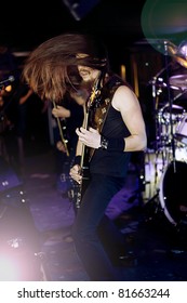 man playing electrical guitar. wind in hair.