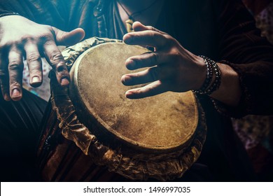 A Man Playing An Ethnic Percussion Musical Instrument Jembe. Drummer Playing African Music