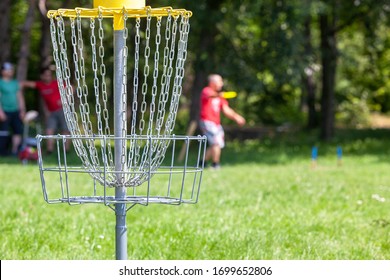 Man playing flying disc golf sport game in the city park