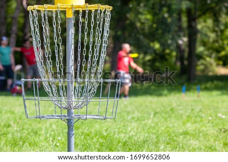 Man playing flying disc golf sport game in the city park
