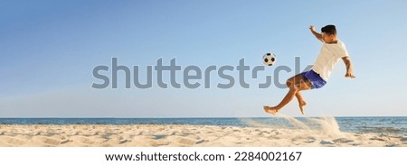 Man playing football on sandy beach, space for text. Banner design
