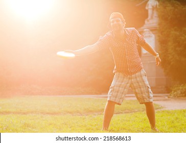 Man Playing Frisbee At Its Yard