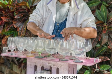 Man Is Playing A Glass Harp.