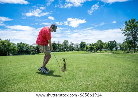 man playing golf with golf club on fairway