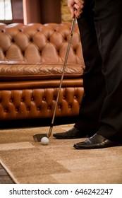 Man Playing Golf At Home Alone. Sport For Recovering Your Nerves After Hard Working Day Or Week. Golf At Home Concept.