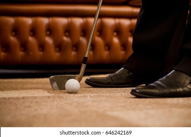 Man Playing Golf At Office Alone. Sport For Recovering Your Nerves After Hard Working Day Or Week. Golf At Office Concept.