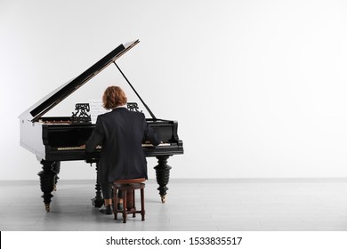 Man Playing Grand Piano At The Concert