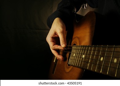 Man Playing Guitar At Black Background