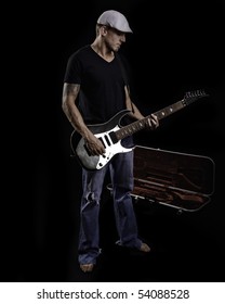 Man Playing Guitar With Case On Black Background.