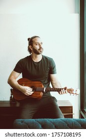 Man Playing Guitar Looking Away Missing Someone Single Lonely At Home Vintage Color Tone Vertical Shot.