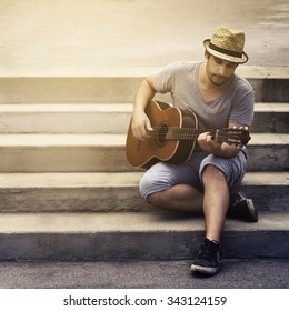 Man Playing Guitar On The Street