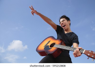 Man Playing Guitar Outdoors