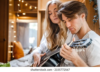 Man Playing Guitar, Singing Song On Small Kitchen,cooking In Van. Young Girl,guy Just Married Couple,lovers Traveling In Camper,house On Wheels,trailer,motor Home. Love Romantic Road Travel Vacation.