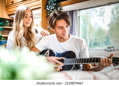 Man Playing Guitar, Singing Song On Small Kitchen,cooking In Van. Young Girl,guy Just Married Couple,lovers Traveling In Camper,house On Wheels,trailer,motor Home. Love Romantic Road Travel Vacation.