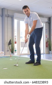 Man Playing Indoor Golf